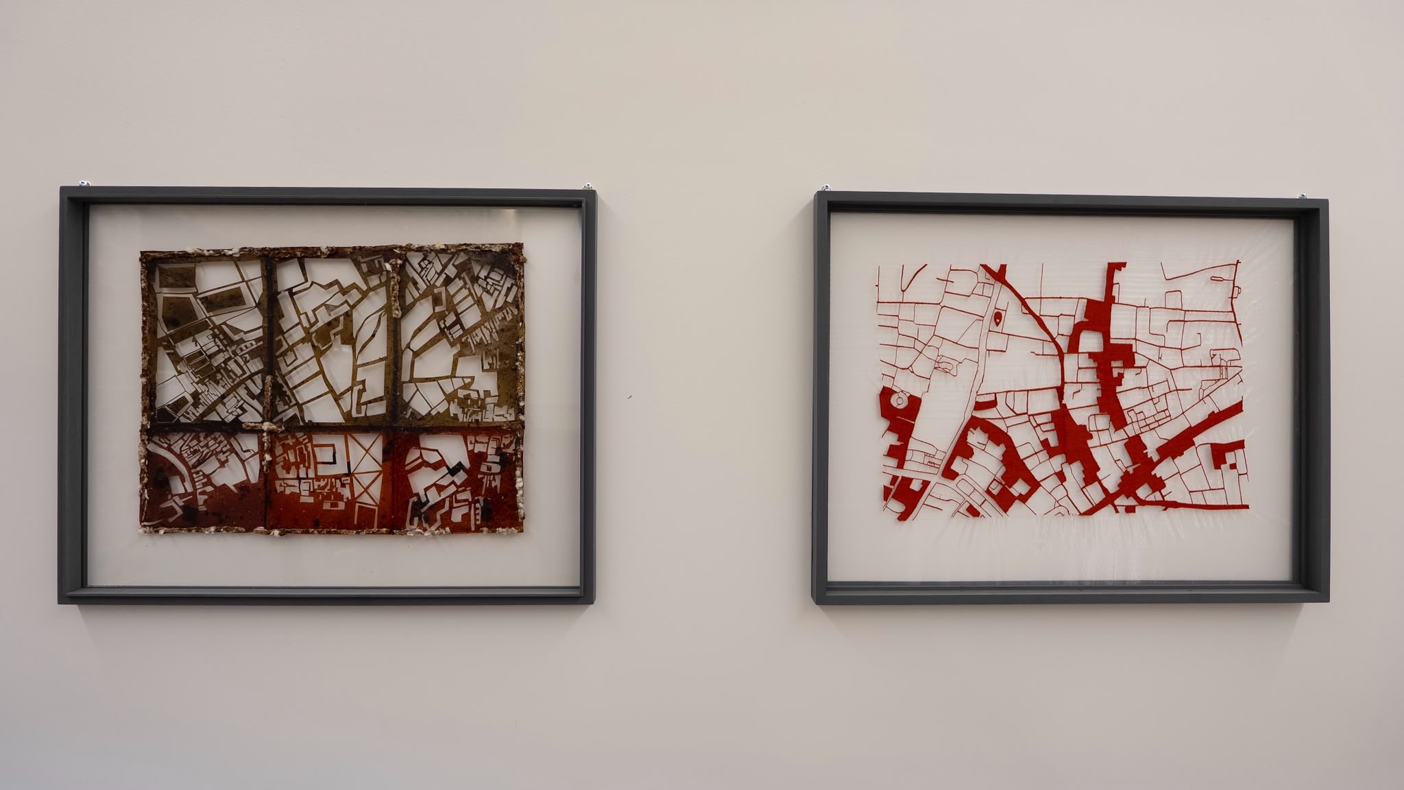 Wide installation view of Layers of Passage, two framed works on a gallery wall