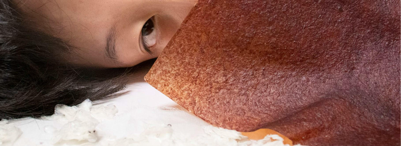 Fish-scale leather held against the face
