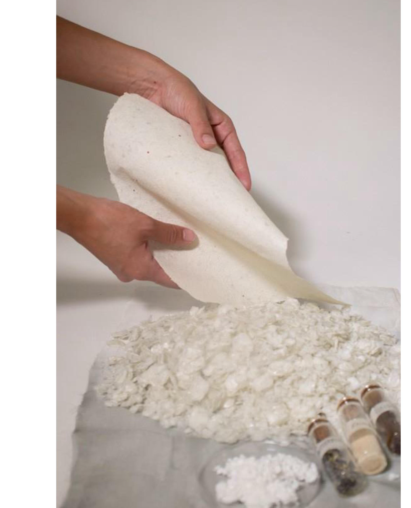 Hands holding a sheet of fish-scale paper
