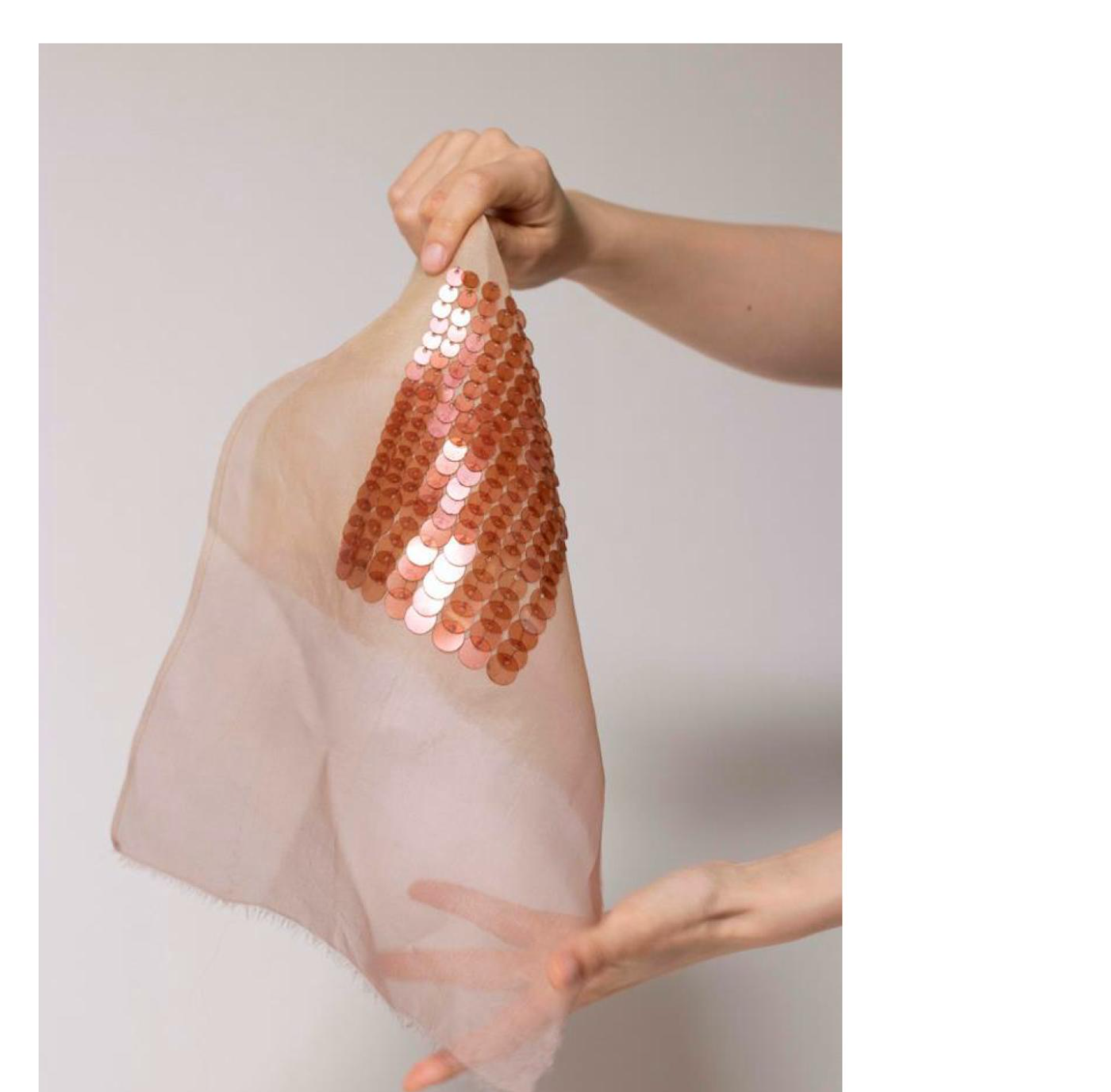Sheer panel of bio-sequins draped and held